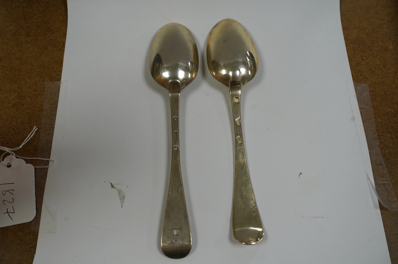 A George I silver Old English pattern table spoon, rubbed maker's mark, London, 1721 and a George III Irish silver table spoon, Dublin, 1760, 136 grams. Condition - fair